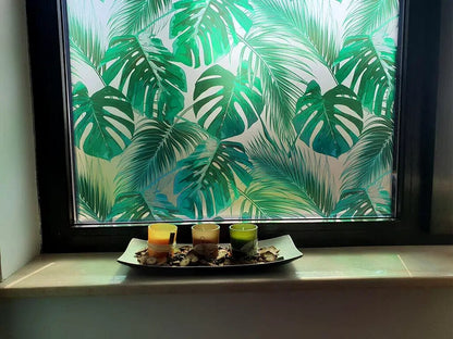 Self-adhesive decorative frosted window film Palmas with tropical pattern with green leaves