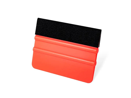 Squeegee for applying film, stickers and decals, made of plastic with one side covered in felt